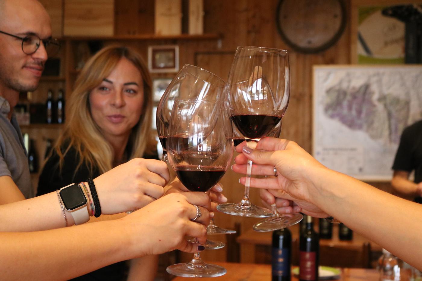 Guests raising a toast with red wine