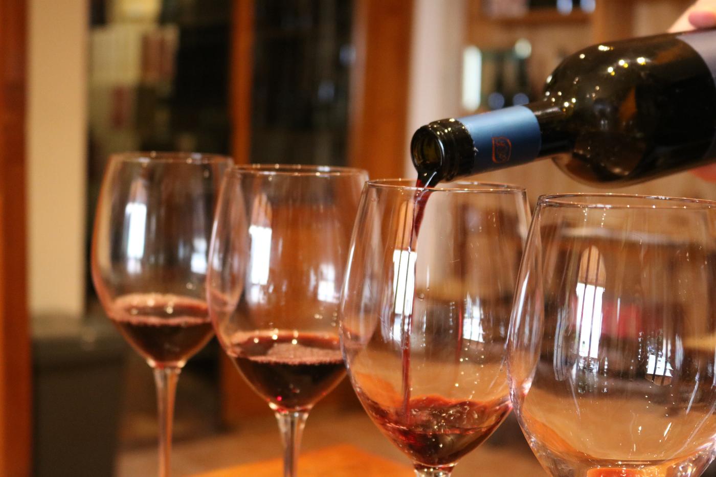 Red wine being poured into glasses